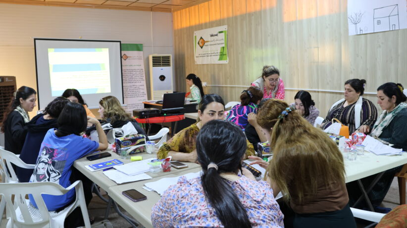 A group of women and girs at during an empowerment training session Under the scope of the interventions vacational skilling is a key component