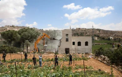 Israeli bulldozer demolishing house of Palestinian family in the West Bank