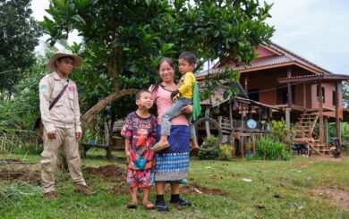 Ms. Vongvilay stands with one of her sons on her arm, and the other by her side smiling to the camera