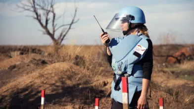 Team leader Olha gives instructions to her team on the minefield